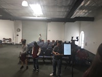 a group of people standing in a room with a camera