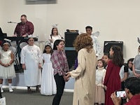 a group of people standing in front of a group of people