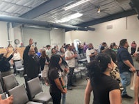 a large group of people standing in a room