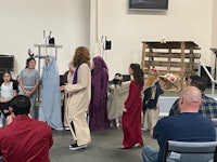 a group of people dressed up in jesus costumes in a church